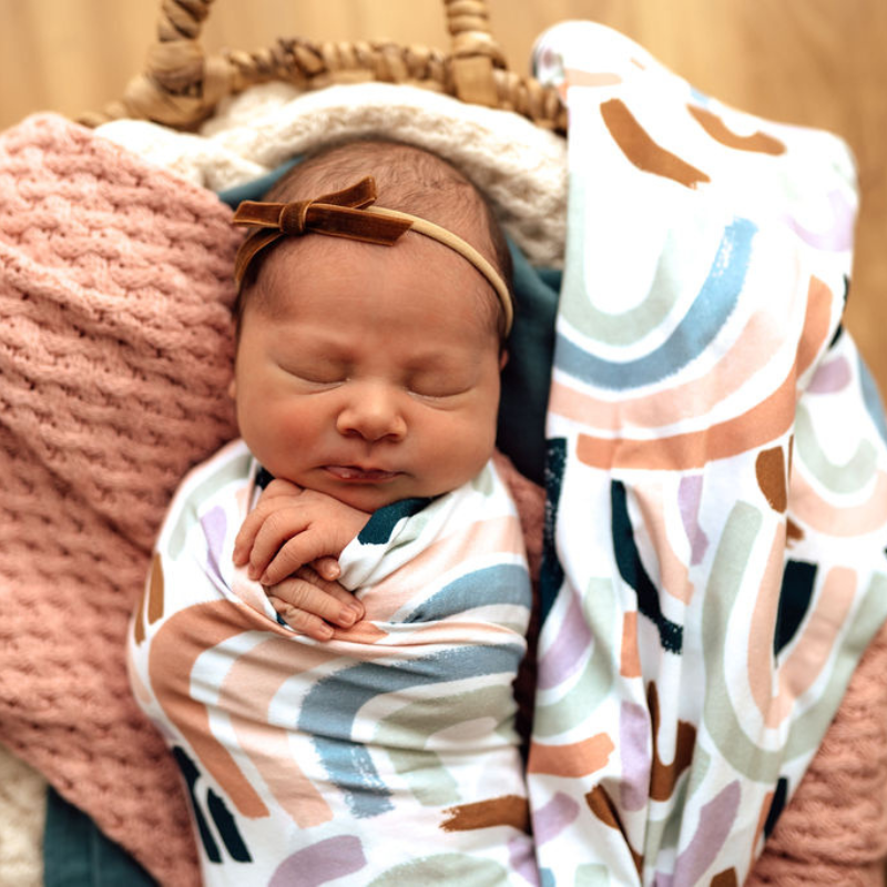 Rainbow Jersey Wrap swaddled on sleeping baby