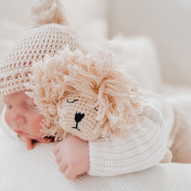 Side view of baby sleeping with Lion comforter