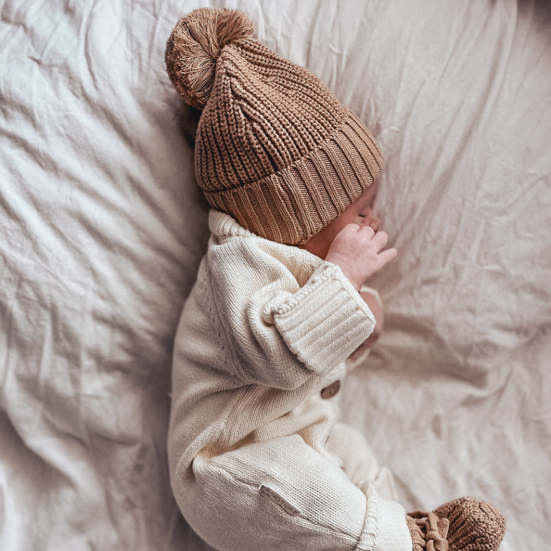 Textured Knit Beanie in Coco on newborn baby sleeping on their side