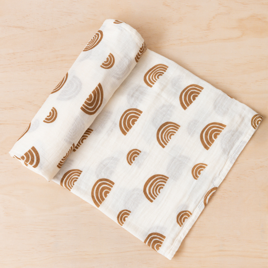 Kiin Swaddle in Ivory Umber rolled out on table