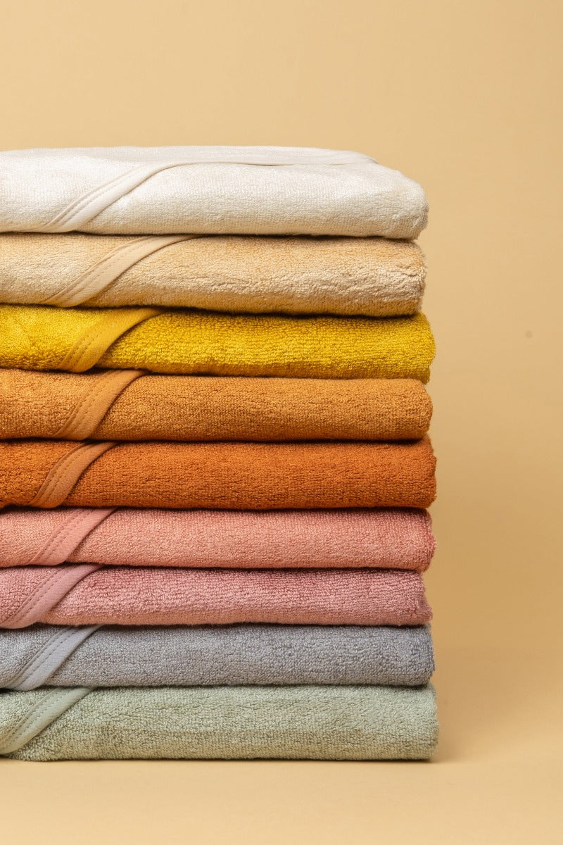 Stack of hooded towels showcasing the colour range