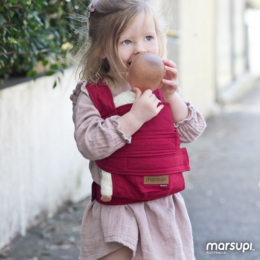 Mini Marsupi Red on toddler with baby doll inside