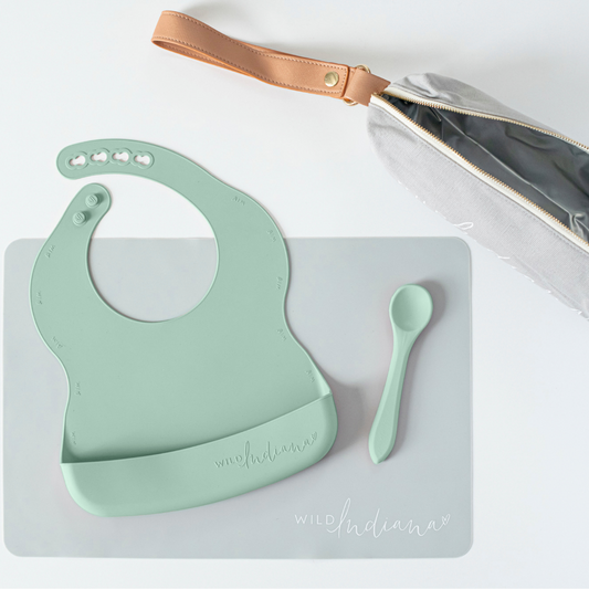 Go Eating Travel set in Sage includes a silicone bib, spoon, placemat and custom travel bag
