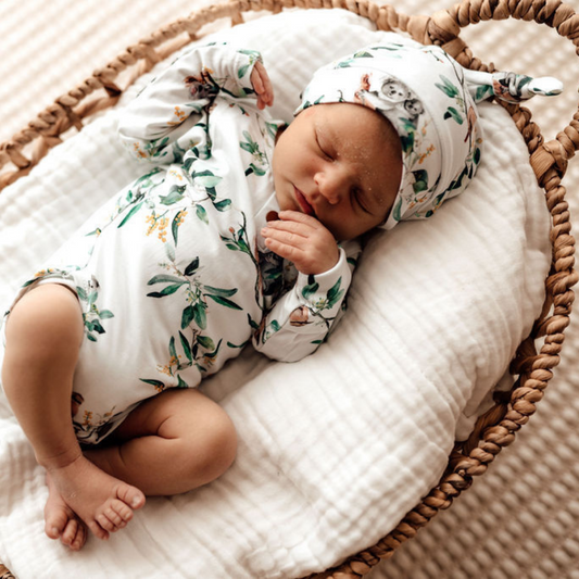 Snuggle Hunny Kids Knotted Beanie Eucalypt on baby with matching bodysuit lying in a moses basket