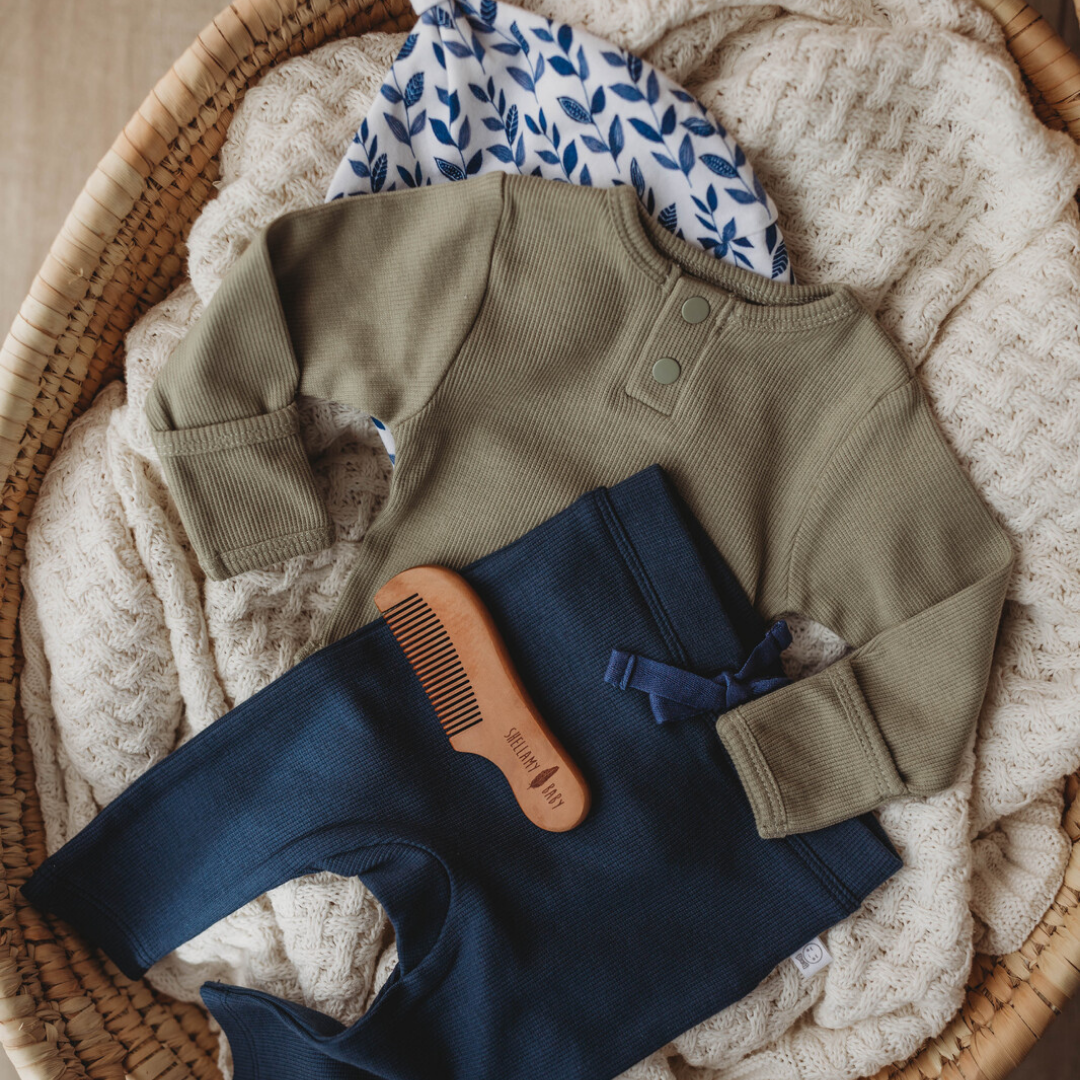 Snuggle Hunny Kids navy baby pants product image paired with complementary baby clothing and accessories